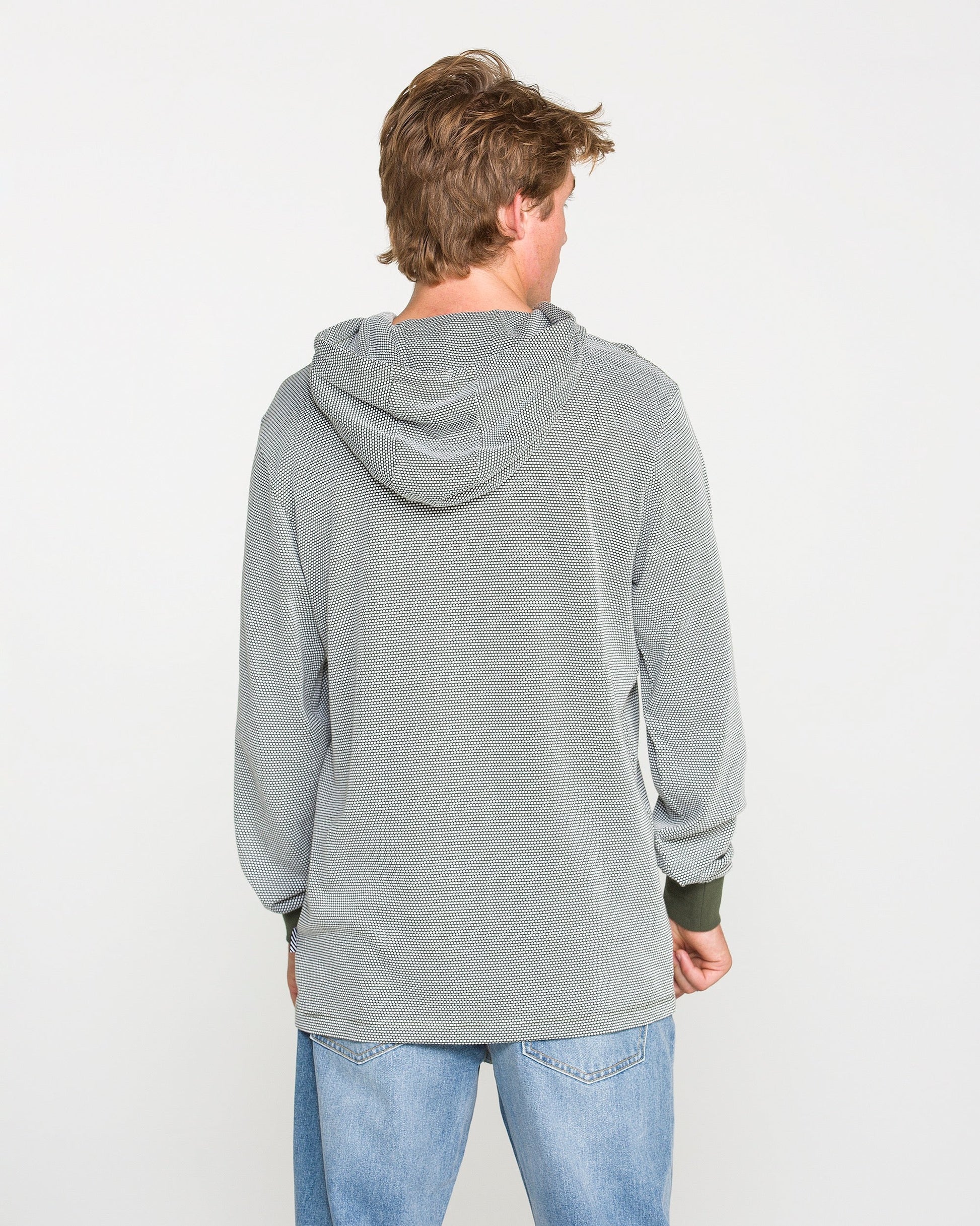 A person with light brown hair, wearing the Volcom Men's Rowan Thermal Long Sleeve Shirt in light gray and blue jeans, is standing facing away from the camera against a plain white background.
