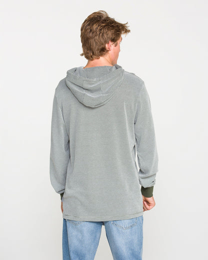 A person with light brown hair, wearing the Volcom Men's Rowan Thermal Long Sleeve Shirt in light gray and blue jeans, is standing facing away from the camera against a plain white background.