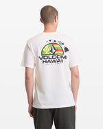 A man wears the Volcom Men's Allegiance Short Sleeve Tee, featuring a colorful Hawaii logo and Hawaiian Islands graphic on the back, against a plain white background.