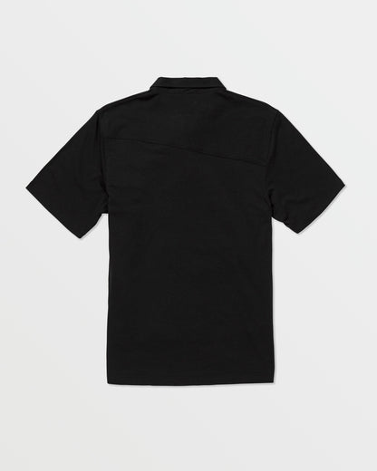 The Volcom Kids' Wowzer Polo Short Sleeve Tee, a plain black modern fit shirt, is displayed from the back and laid flat on a white background.