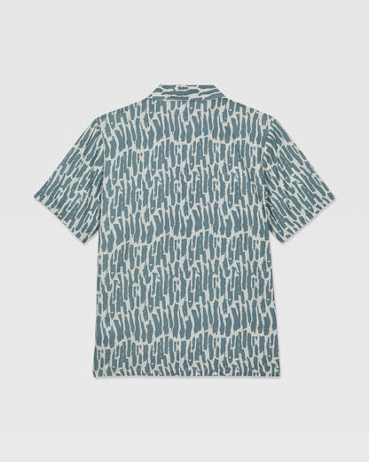 The Volcom Kids' Boldstone Short Sleeve Tee features a blue and white abstract brushstroke pattern, shown flat from the back.