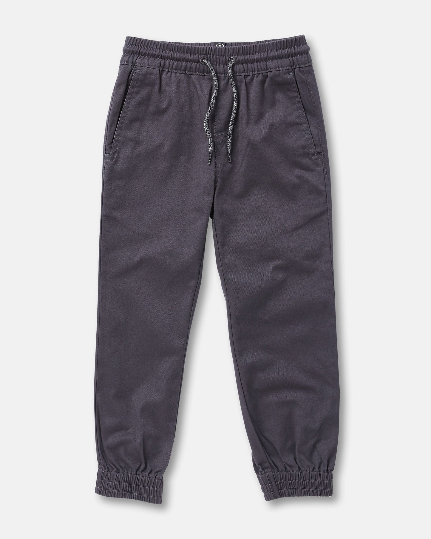 The Volcom Kids' Big Boys Frickin Slim Joggers in dark gray, made with recycled fibers, feature an elastic waist with drawstring, two side pockets, and elastic ankle cuffs; pants shown laid flat on a white background.