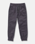 The Volcom Kids' Big Boys Frickin Slim Joggers in dark gray, made with recycled fibers, feature an elastic waist with drawstring, two side pockets, and elastic ankle cuffs; pants shown laid flat on a white background.