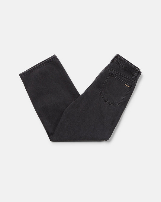 A pair of Volcom Boy's Big Boys' Billow Denim II Pants in black, folded neatly on a white background with the back pocket and waistband visible.