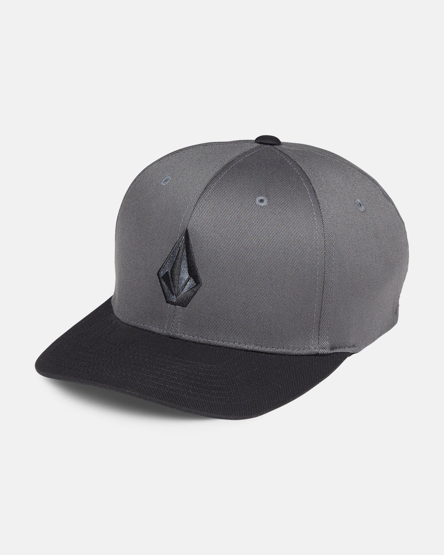 The Volcom Men's Full Stone Flexfit Hat features a gray structured stretch twill design, black brim, and an embroidered black geometric logo on the front, shown against a plain white background.
