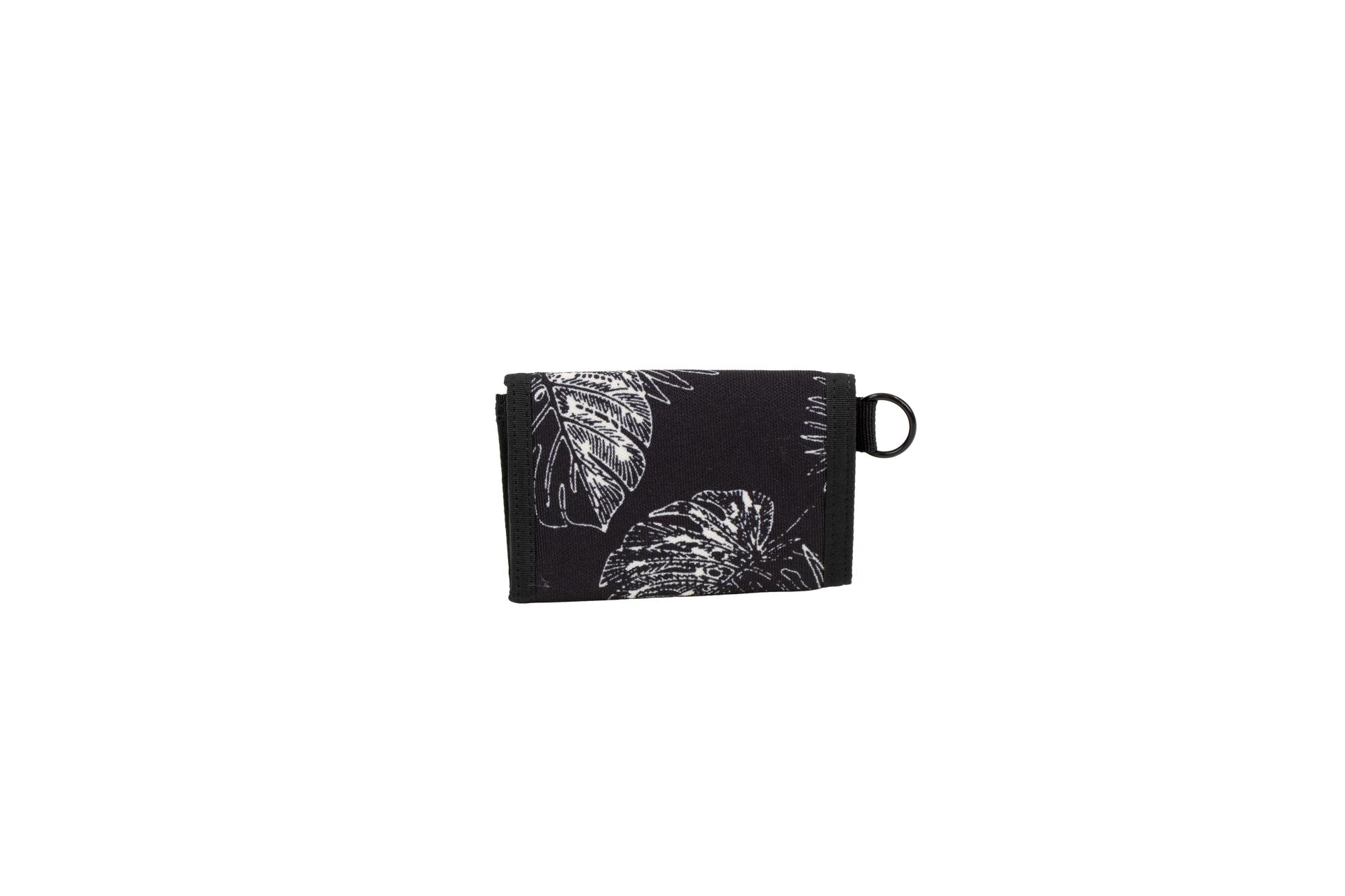 A black cotton canvas wallet with a white leaf and flower pattern, folded closed, featuring a small black loop on the right side, is displayed against a plain white background. The Men’s Box Stone Wallet from Volcom combines style and practicality in a compact design.