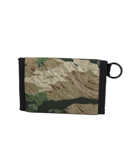 The Volcom Men's Box Stone Wallet features a camouflage-patterned cotton canvas design with black trim and a black key ring attached to one side, displayed against a white background.