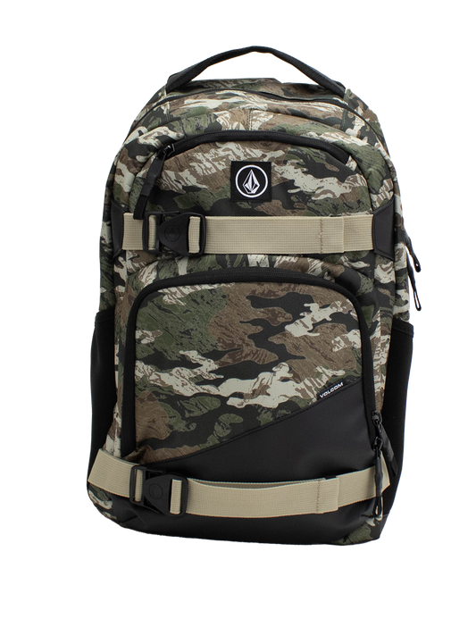 The Volcom Men's Grindstone Skate Backpack features a camouflage pattern with black and beige adjustable straps, two front zippered pockets, a small logo patch, a dedicated laptop sleeve, and side compartments, shown against a plain white background.