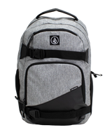 A Volcom Men's Grindstone Skate Backpack in gray and black, featuring two front zippered pockets, black adjustable straps with buckles, a padded laptop sleeve, and a top handle, displayed against a plain white background.