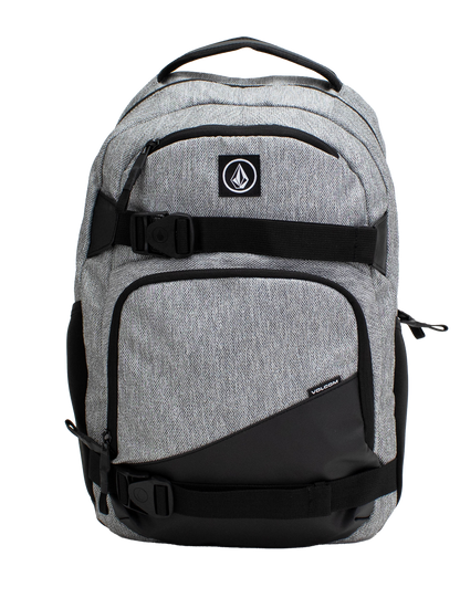 A Volcom Men's Grindstone Skate Backpack in gray and black, featuring two front zippered pockets, black adjustable straps with buckles, a padded laptop sleeve, and a top handle, displayed against a plain white background.