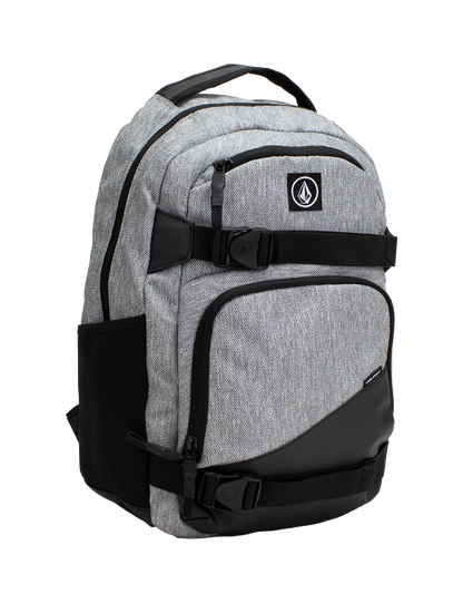 Volcom Men's Grindstone Skate Backpack in gray and black features multiple zippered compartments, side pockets, and a top handle. This backpack includes a logo patch on the front, adjustable straps, and a padded laptop sleeve for added convenience.