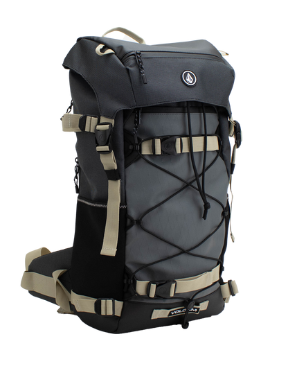 The Volcom Men's Peakstone Mountain Backpack is a durable gray and black daypack featuring beige straps, side pockets, a front bungee cord, and a top handle, shown against a white background.