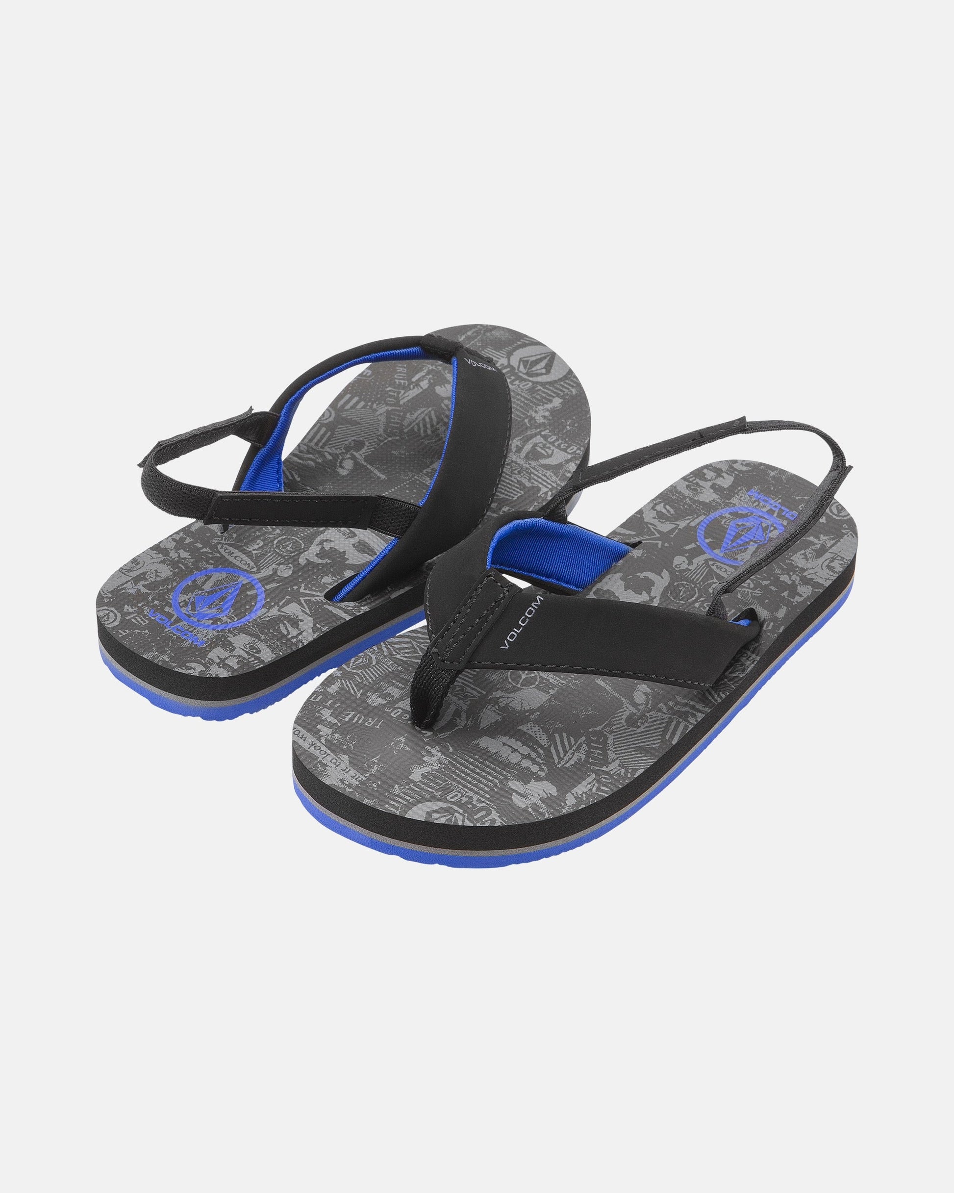 The Volcom Kids' Victor 2 Little Youth sandals feature black and blue straps, printed gray graphic footbeds, adjustable back straps, and Recliner Comfort Foam for extra cushioning.