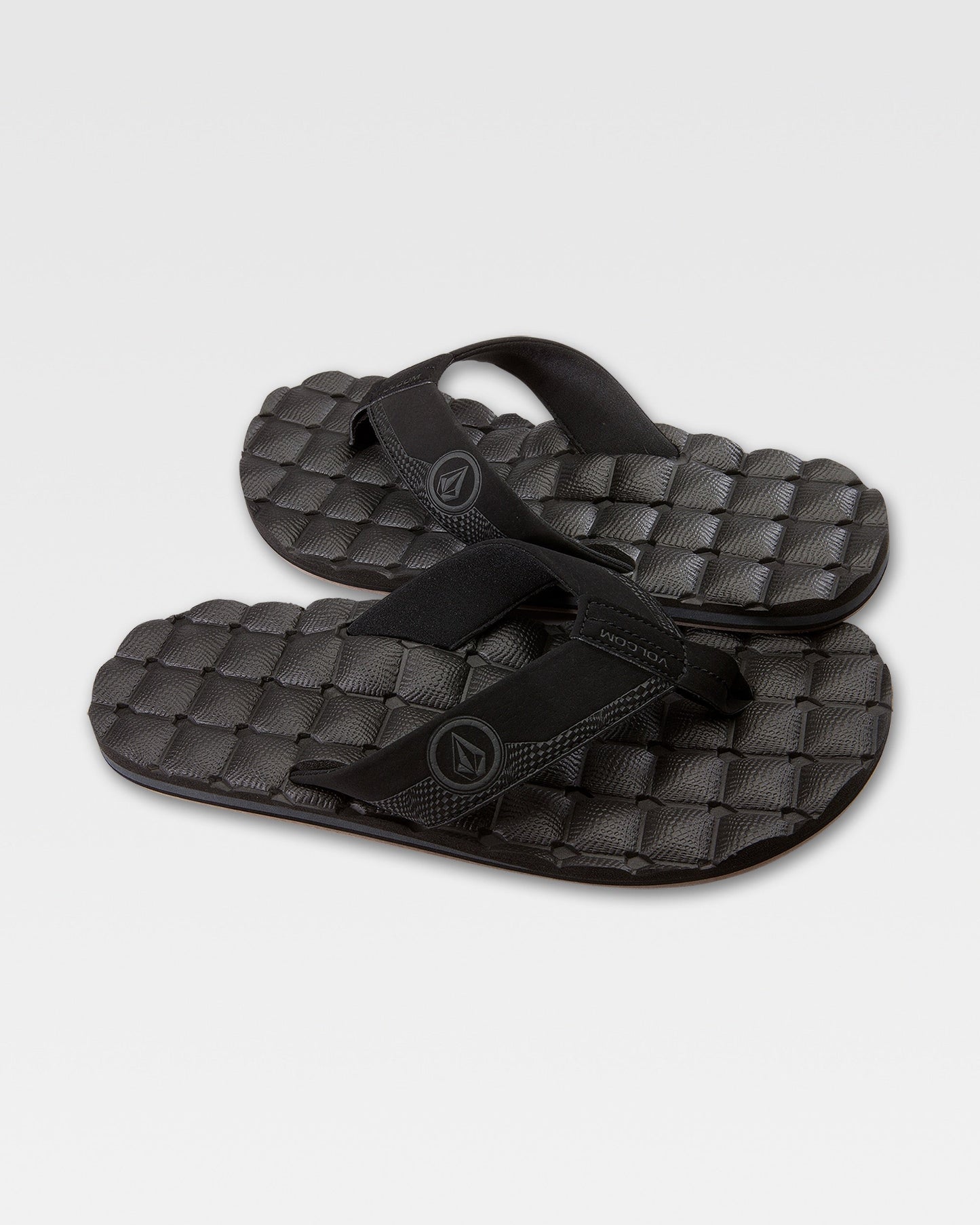 The Volcom Recliner sandals feature thick straps and a cushy, woven-pattern sole for a comfortable, grippy step—shown here in black against a plain white background.