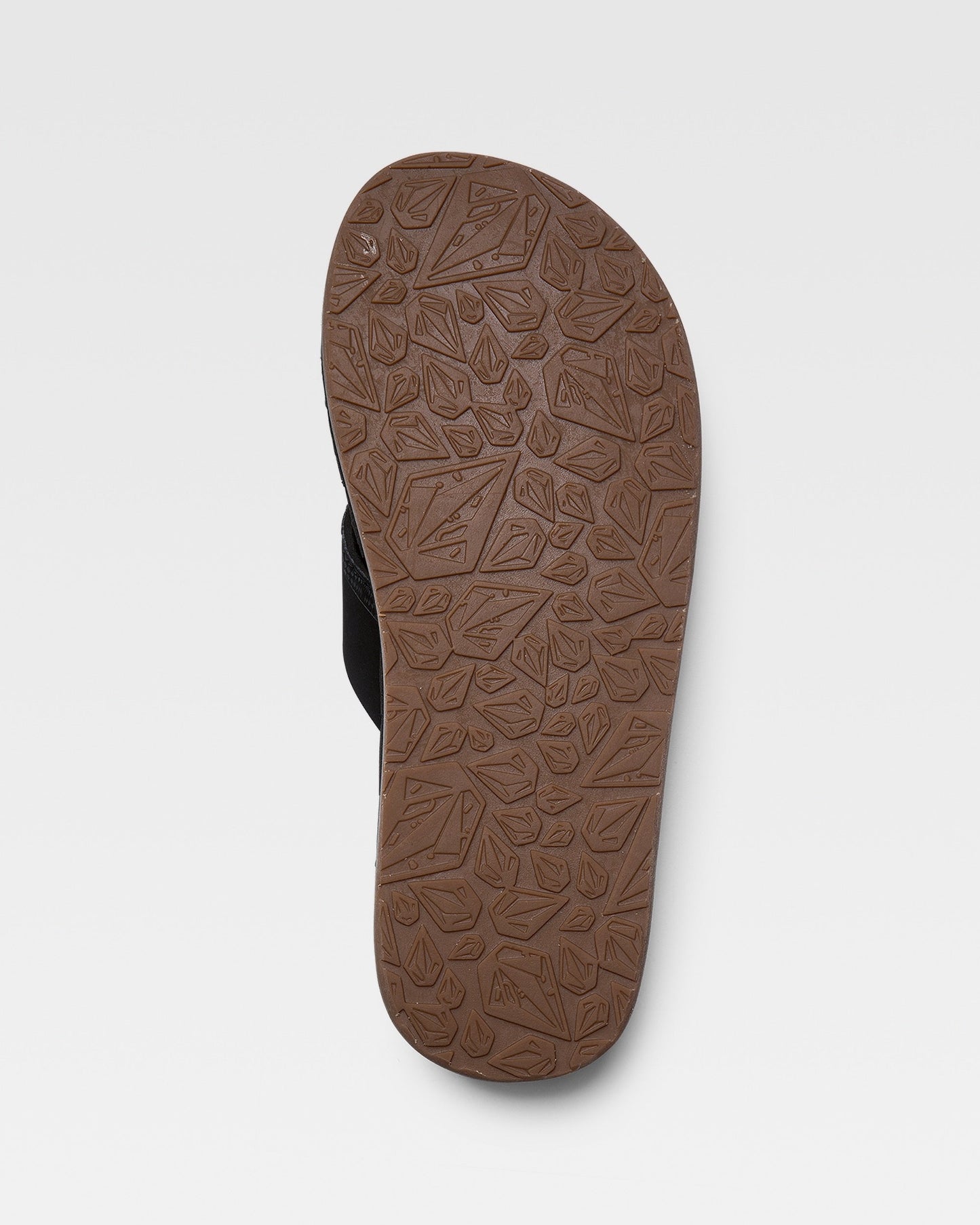 The image shows the brown sole of a Volcom Recliner sandal, featuring a leaf and geometric pattern, photographed from the bottom against a plain white background.