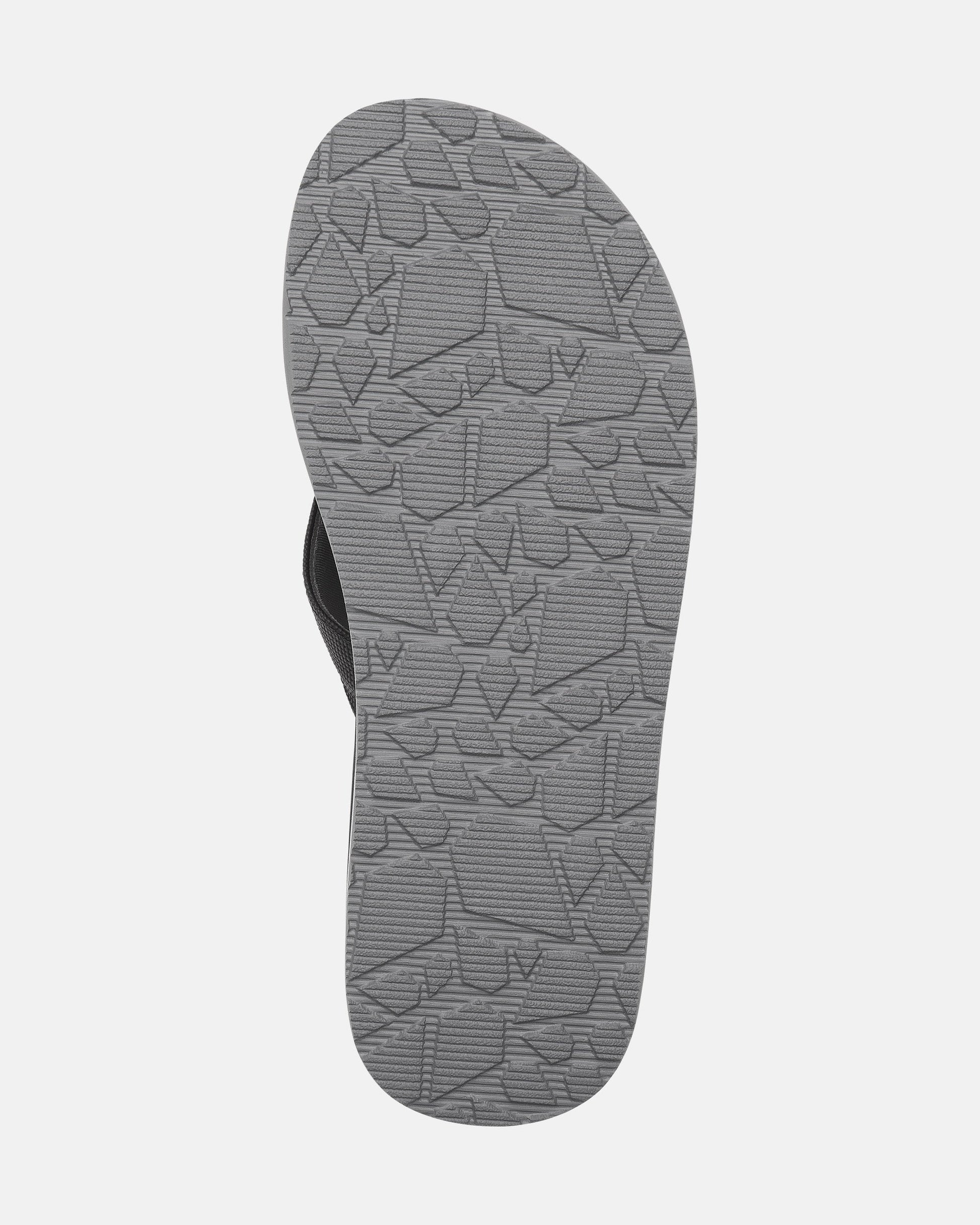 The image features the sole of the Men’s Victor Sandals by Volcom in gray, displaying a textured geometric tread pattern. Set against a white background, it highlights the water-friendly design of these sandals.
