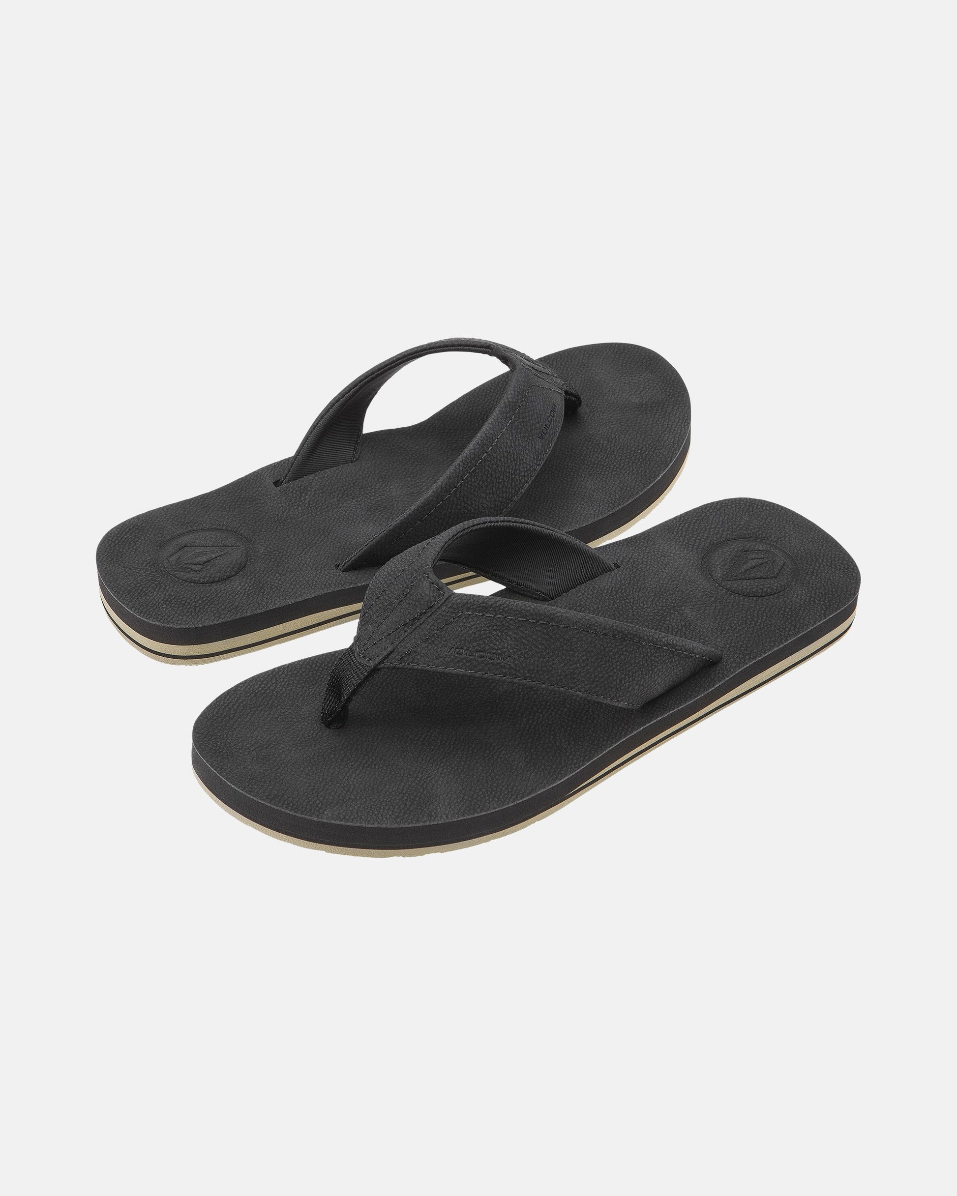 A pair of Men's Victor Sandals LX by Volcom in black, featuring textured straps and soles, displayed on a plain white background at an angle to show both the top and side views. Water-friendly design.
