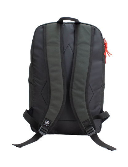 The Volcom Men's School Backpack is displayed from the back against a plain white background. It features ergonomic, padded shoulder straps, adjustable chest and waist straps, and a small Volcom logo near the bottom. A red zipper pull accents the right side. Inside, a padded laptop sleeve offers secure storage for your device.