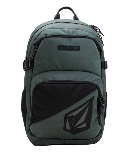 The Volcom Men’s Exponent Backpack in green features black zippers, a front pocket with the Volcom logo, and a top handle. This spacious backpack provides organized storage with two main zippered compartments and convenient side straps.