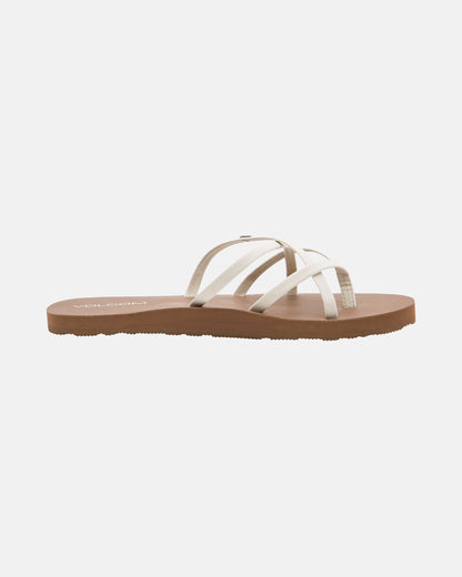 The Volcom Women's New School II sandal features thin, crisscrossed synthetic leather straps and a flat brown sole with Recliner Comfort Foam, displayed on a plain white background.