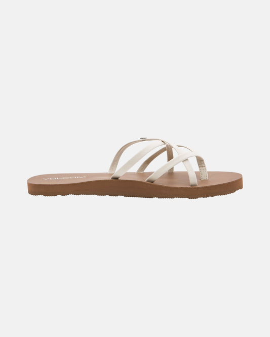 The Volcom Women's New School II sandal features thin, crisscrossed synthetic leather straps and a flat brown sole with Recliner Comfort Foam, displayed on a plain white background.