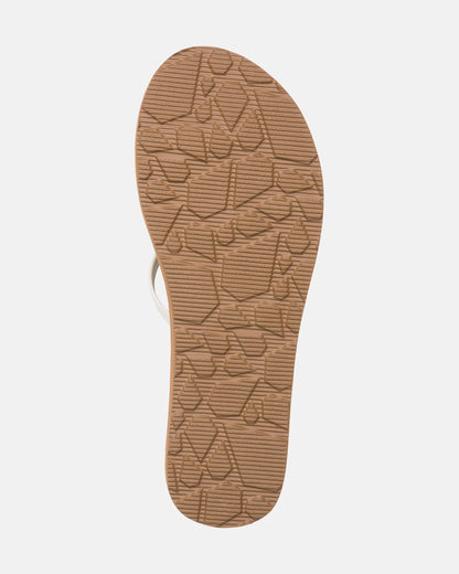 The image displays the sole of Volcom Women's New School II sandal in tan, featuring a textured geometric pattern for grip and molded arch support. Synthetic leather straps are partially visible at the top against a white background.