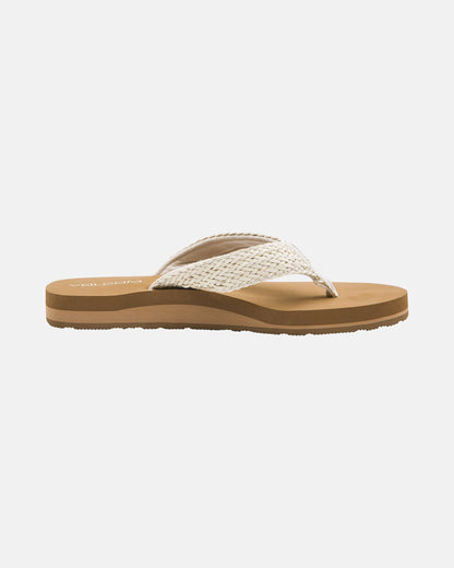 The Volcom Women's Oasis Sandals feature a tan flip-flop design with a textured, woven white strap and brown cushioned sole, shown in side view on a plain white background.