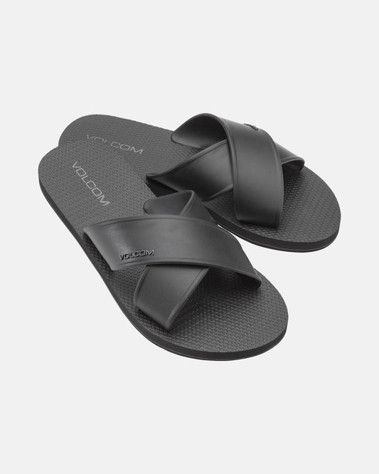 The Women's Volcomotion Strap Sandals by Volcom feature black crisscross straps and textured soles, with the brand name visible on the straps and footbeds, displayed against a plain white background.