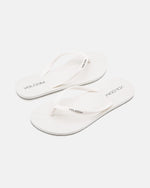 A pair of Volcom Volcomotion Womens white flip-flops with thin straps, featuring the black Volcom logo on the footbeds and straps, shown against a plain white background.