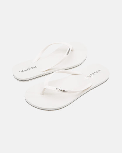 A pair of Volcom Volcomotion Womens white flip-flops with thin straps, featuring the black Volcom logo on the footbeds and straps, shown against a plain white background.