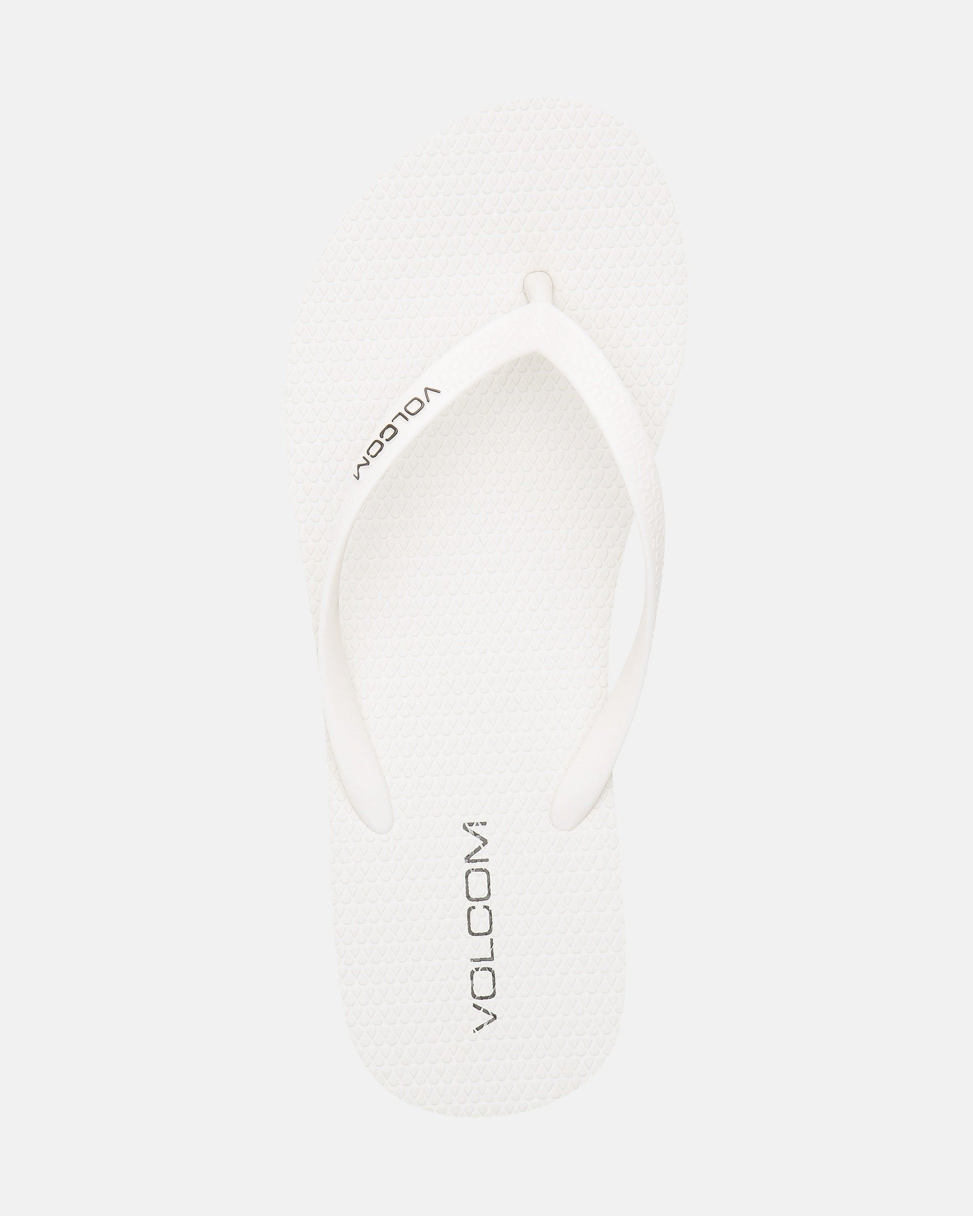 A single Volcomotion Womens white flip-flop sandal by Volcom, featuring the brand name in black on the footbed, displayed against a plain white background.